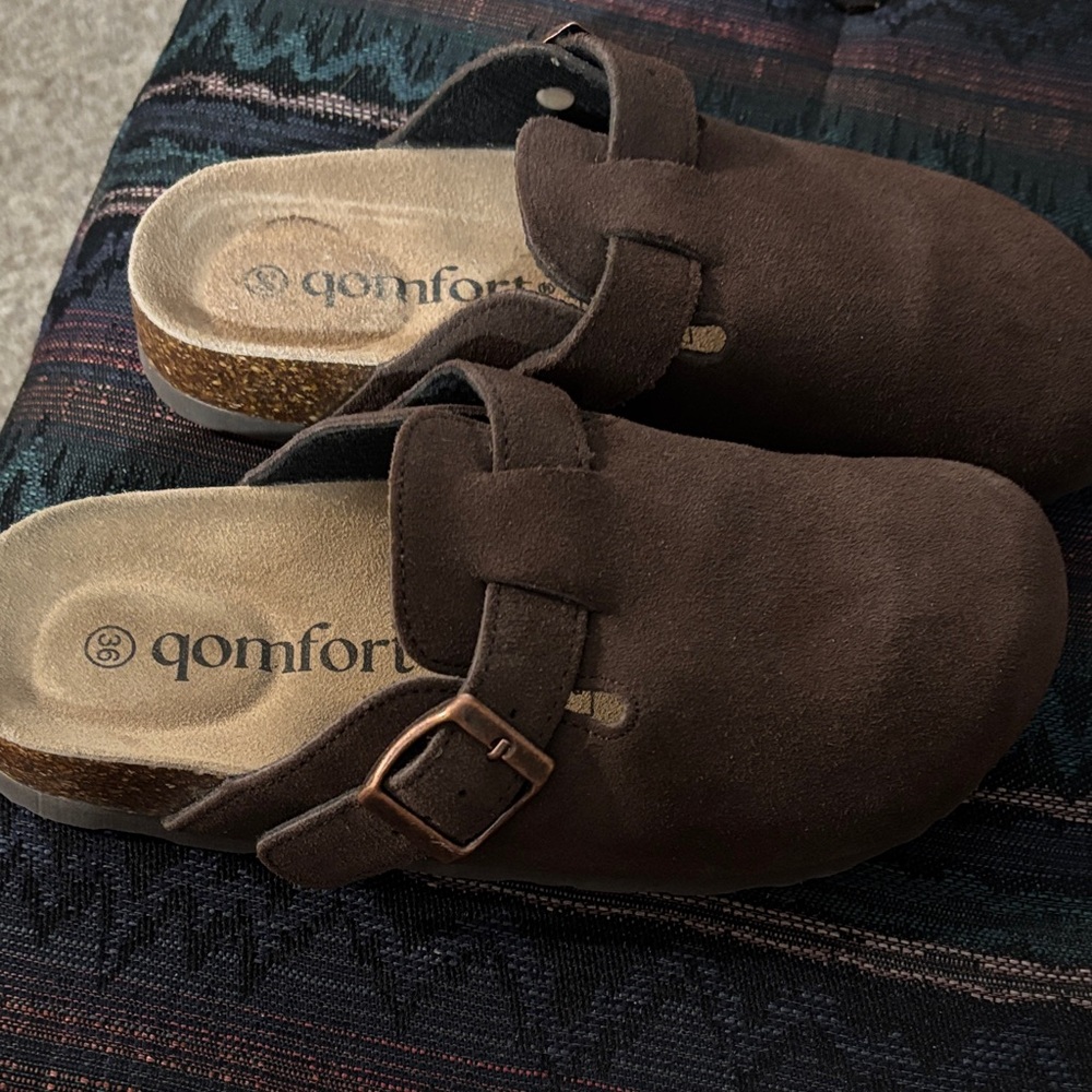 Brown clogs or slides.